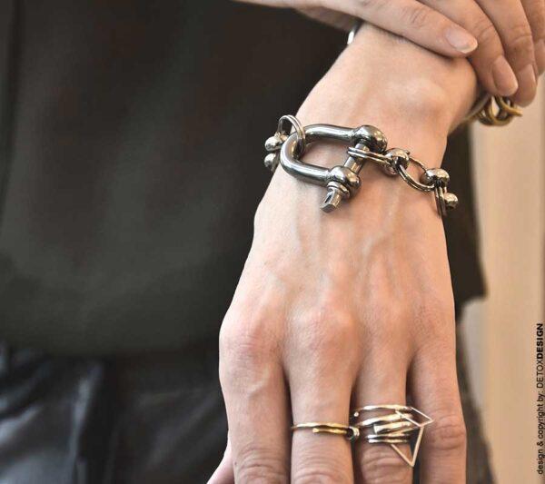 Zdjęcie pokazuje w zbliżeniu kobiecy nadgarstek a na nim obłędna bransoletka unisex z szeklą a to biżuteria też dla mężczyzn.